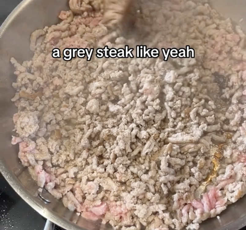 ground meat browning in a frying pan